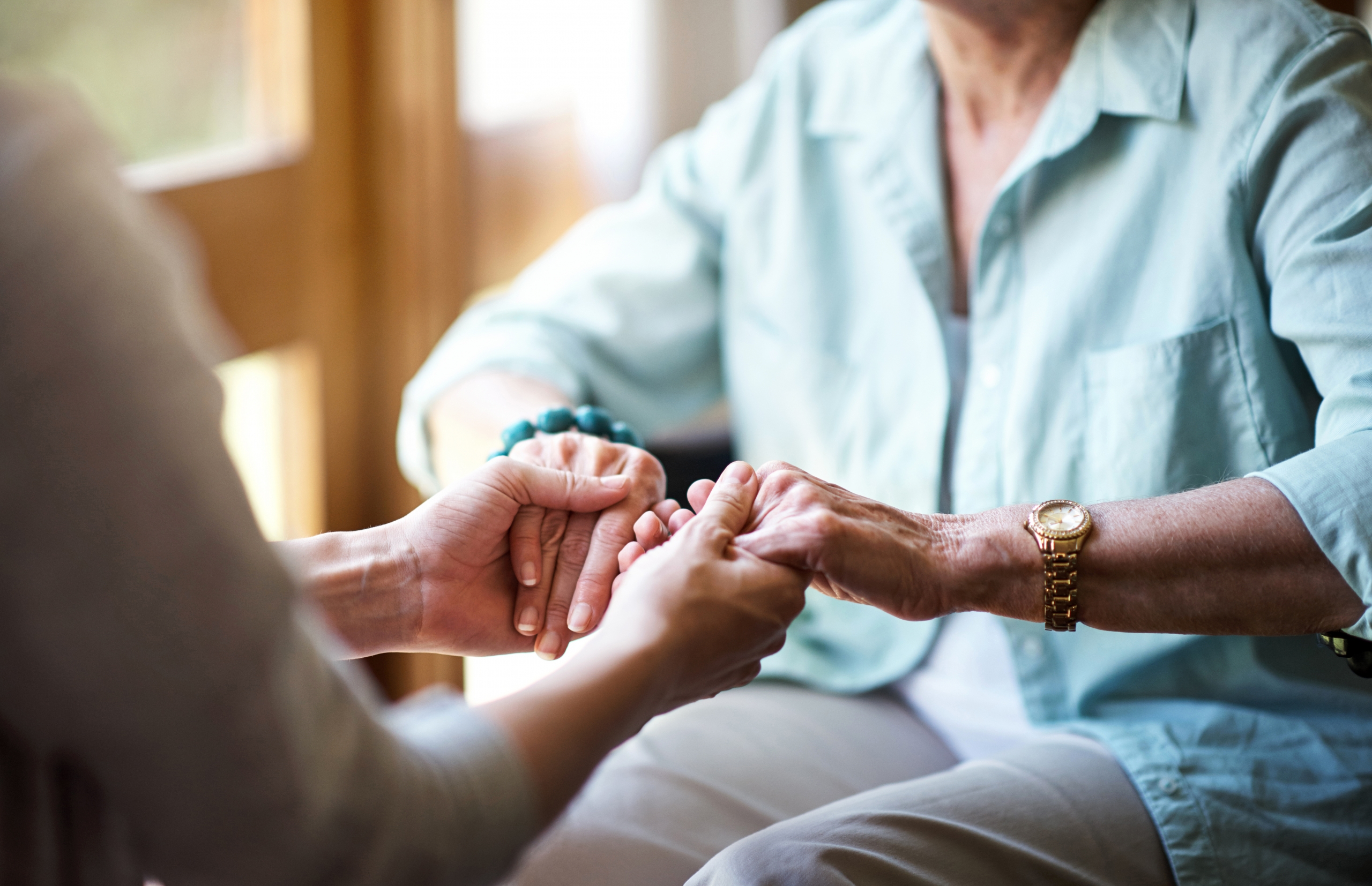 young woman comforting senior woman