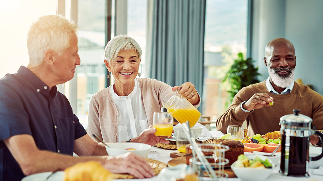 senior residents enjoying breakfast with one another
