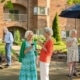 seniors having drinks and conversing at the outdoor campus of HCK