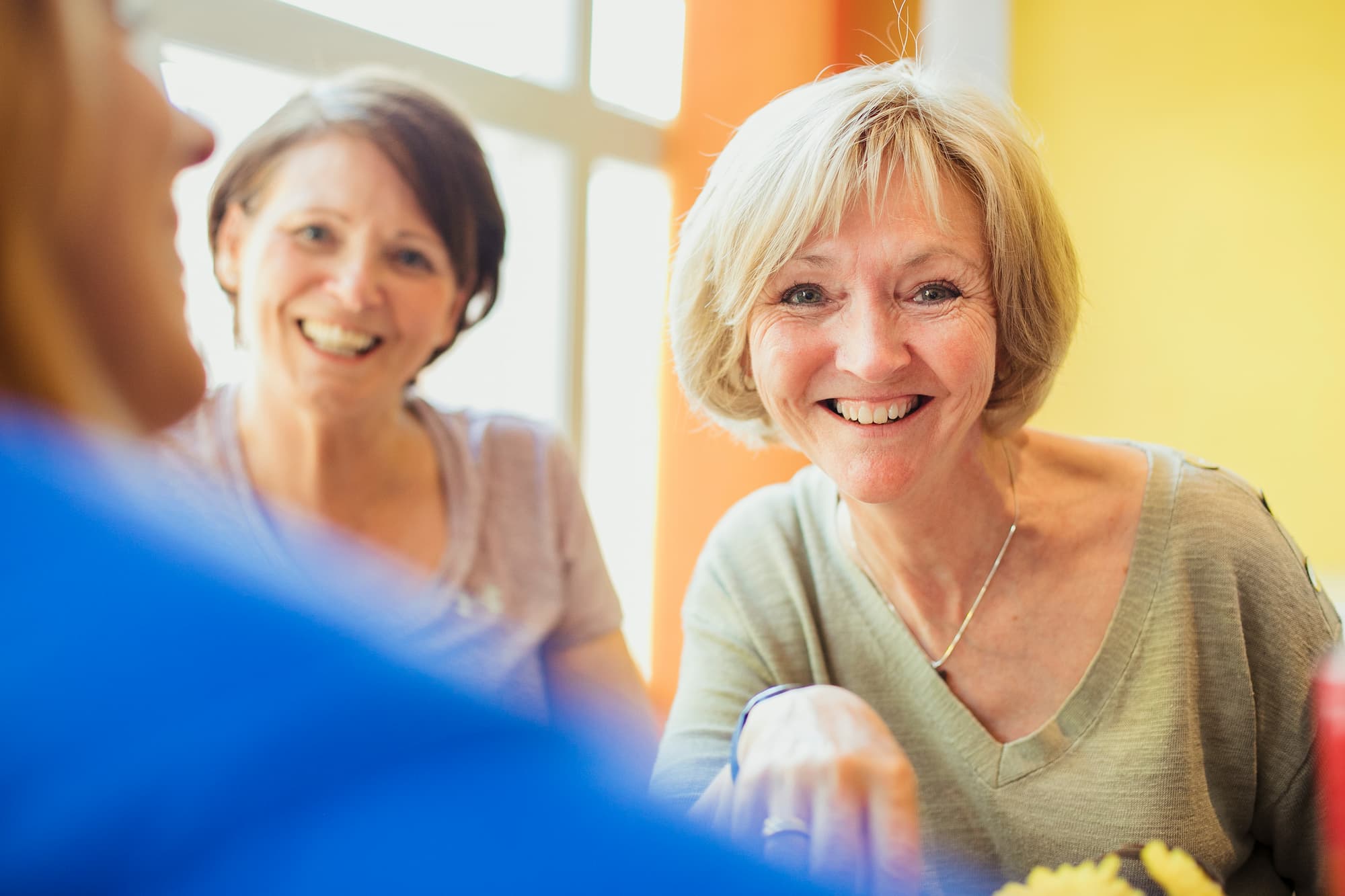 two woman laughing and smiling