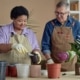 Older active man and women doing indoor gardening together as one of their hobbies