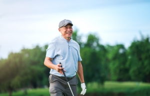 senior man smiling while playing golf