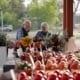 A senior man and senior woman looking at flowers found at the Fresh on Q in TexasTownship