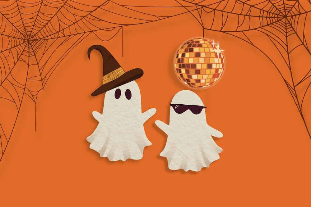 Graphic of two ghosts with a witch hat and sunglasses posing under an orange disco ball and cobwebs.